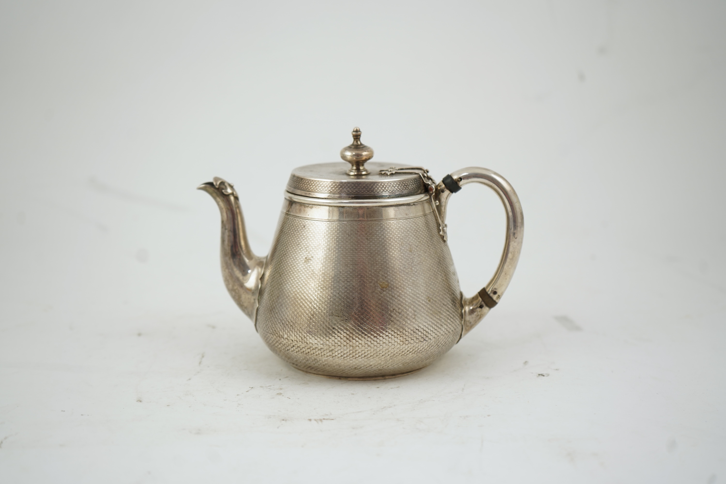 A Victorian engine turned silver teapot by Hunt & Roskell
